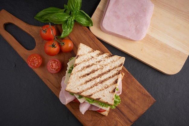 Grilled Sandwich with Ham, Cheese, Tomato, and Lettuce on Wooden Cutting Board – Free Stock Photo, Download Free