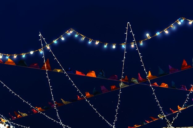 Colorful Glowing Flags and Garlands Against a Dark Blue Sky – Free Stock Photo Download