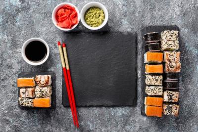 Flat Lay of Maki Sushi Rolls with Chopsticks and Soy Sauce on Blank Slate – Free Download