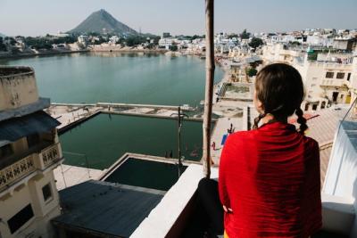 Western Woman Enjoying the Scenic View of Pushkar Lake in Rajasthan – Free Download