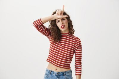 Confident Woman Mocking with Loser Gesture – Free Stock Photo, Download for Free