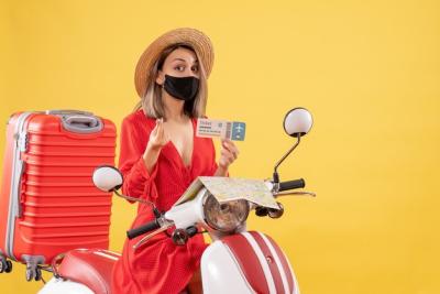 Young Lady with Black Mask on Moped Holding Ticket and Making Money Sign – Free Download