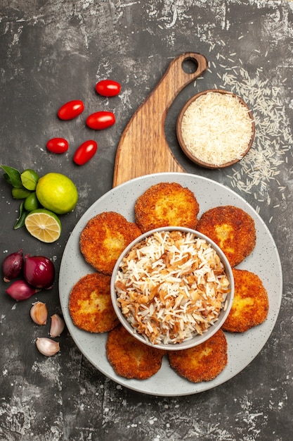 Tasty Fried Cutlets with Cooked Rice on Dark Surface – Free Download