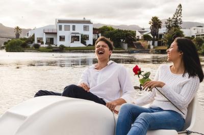 Couple Enjoying a Laugh on a Pedal Boat – Free Stock Photo for Download