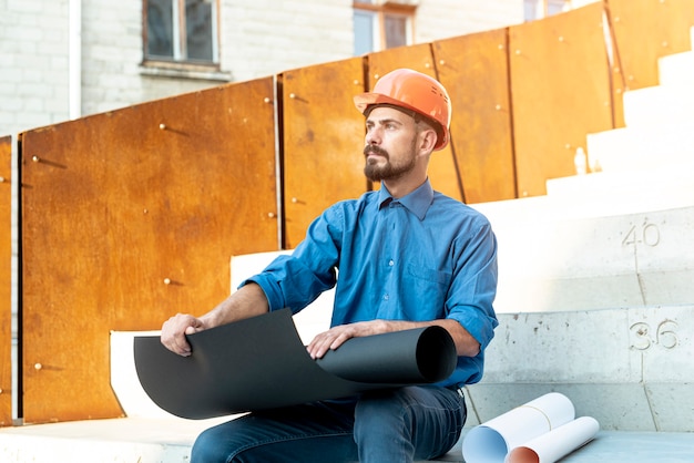 Man with Helmet and Schematics – Free Stock Photo for Download