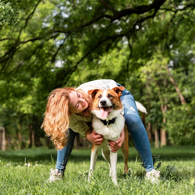 Joyful Moments of a Woman Playing with Her Dog in the Park – Free Stock Photo for Download