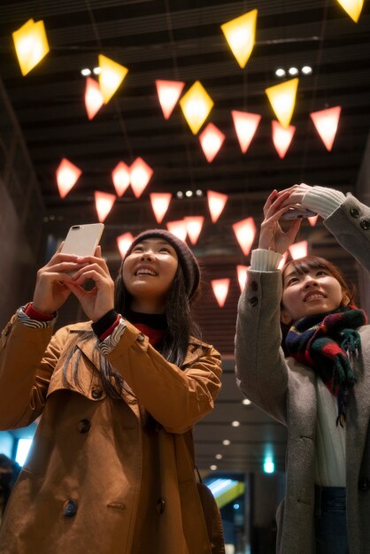 Medium Shot of Smiley Girls Taking Photos – Free Download