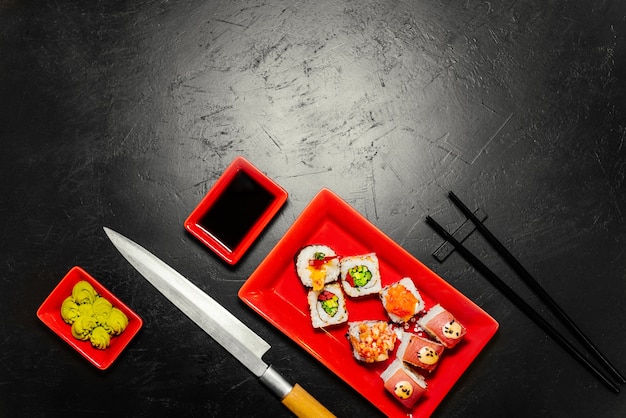 Explore a Set of Sushi, Japanese Knife, and Chopsticks on a Dark Stone Table – Free Download