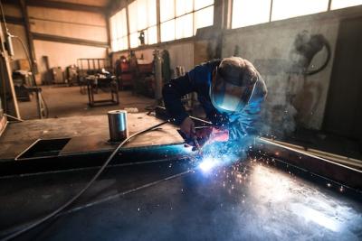 Professional Welder Working on Metal Construction Parts in Industrial Workshop – Free Download