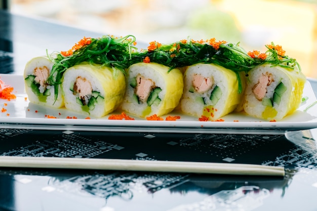 Sushi Rolls with Fried Salmon and Cucumber Topped with Seaweed – Free to Download