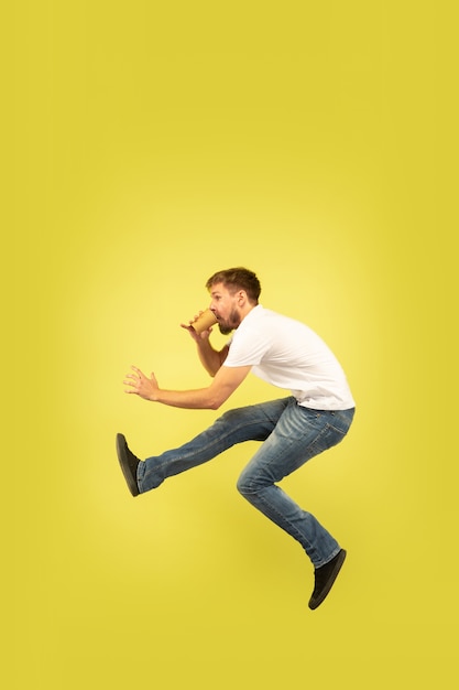 Happy Jumping Man Against Yellow Wall – Free Download