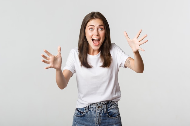 Excited Brunette Girl Smiling and Raising Hands – Free Stock Photo for Download