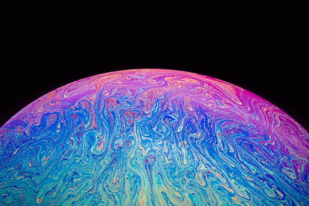 Gradient Hued Rippled Soap Bubble on Black Background – Free Download