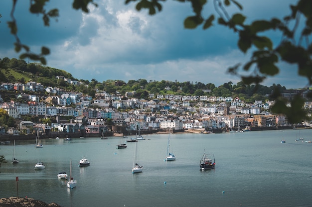 Stunning Boats at the Beach Near a Scenic Hill City – Free Download