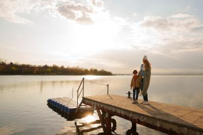 Mother and Son Relaxing on a Jetty – Free Download