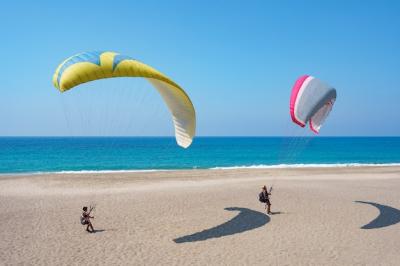 Paraglider Tandem Flying Over the Blue Lagoon in Turkey – Free Stock Photo for Download