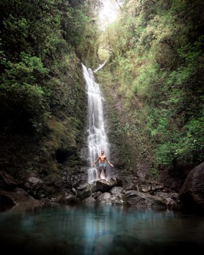 Shirtless Man by a Serene Waterfall and Lush Greenery – Free Stock Photo for Download