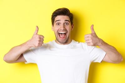 Handsome Young Man Smiling and Giving Thumbs Up – Free Download