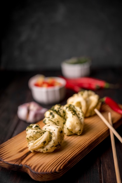 Asian Food on Wooden Board with Garlic and Chopsticks – Free Download