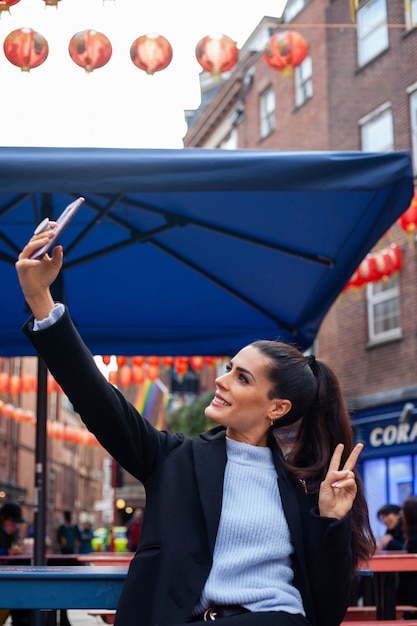 Female Traveler Taking a Selfie with Her Smartphone – Free Stock Photo for Download