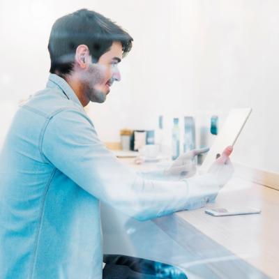 Smiling Man Using Tablet – Free Stock Photo for Download