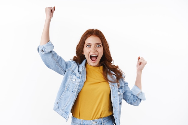 Motivated Redhead Woman in Denim Jacket Celebrating Triumph – Free Stock Photo for Download