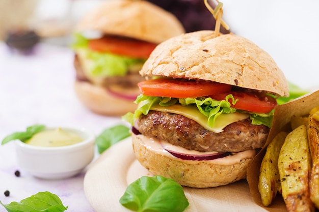 Juicy Hamburger Sandwich with Beef, Cheese, Tomato, and French Fries – Download Free Stock Photo