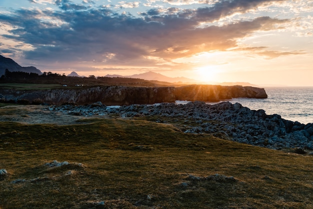 Mesmerizing Beach Sunset Surrounded by Rocky Mountains – Free Download