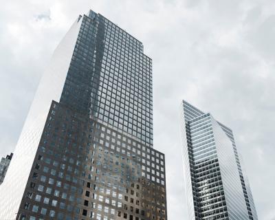 Low Angle View of Tall Buildings Under Grey Clouds – Free Download