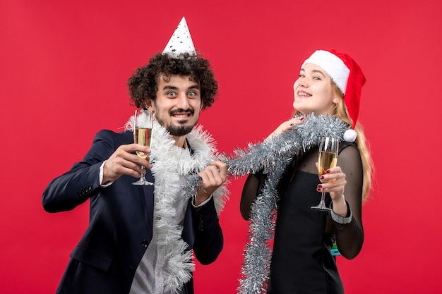 Young Couple Celebrating New Year Against a Red Wall – Free Download