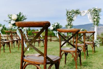 Floral Decoration with White Eustomas and Ruscus on Brown Chiavari Chairs at Outdoor Wedding Ceremony – Free Stock Photo for Download
