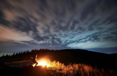 Relaxing Young Man by a Bonfire in the Mountains – Free Stock Photo, Download Free