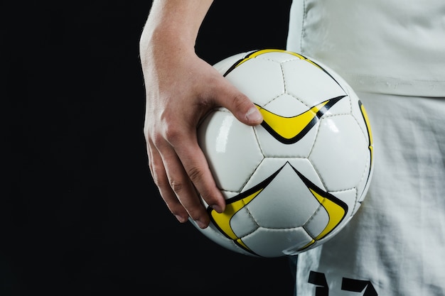 Close-Up of Hand Holding a Soccer Ball – Free Download