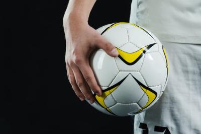 Close-Up of Hand Holding a Soccer Ball – Free Download