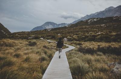 Stunning View of Mount Cook in New Zealand with a Man Walking in Hooker Valley – Free Download