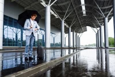 Young Redhaired Businessman Holding Black Umbrella in Rain at Station – Free Download