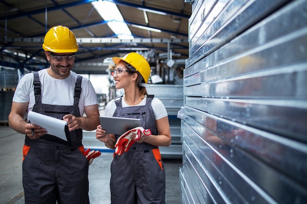 Factory Workers Discussing Production Efficiency in Industrial Plant – Free Download