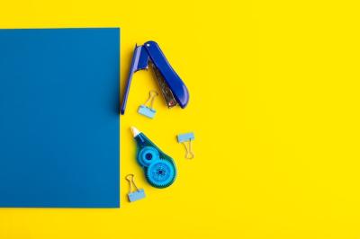 Open Blue Copybook with Stickers on Yellow Surface – Free Stock Photo, Download for Free