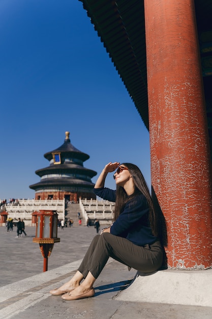 Brunette Girl Sitting on Temple Steps in China – Free Download