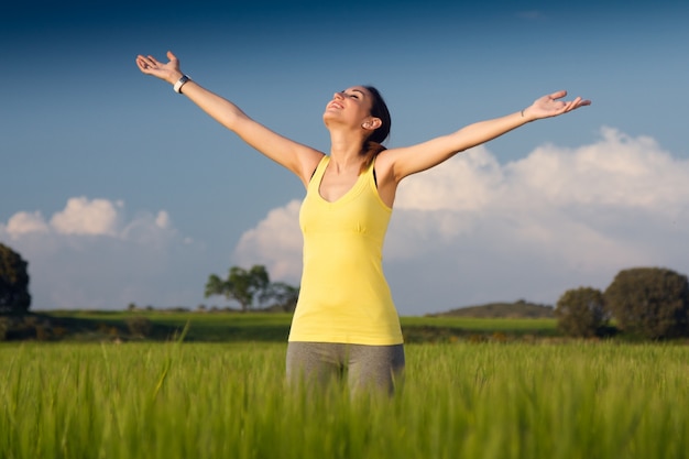 Springtime Bliss: Beautiful Young Woman in a Cereal Field – Free Download