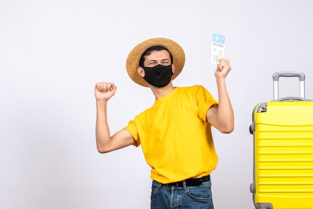 Happy Young Man in Yellow T-Shirt with Travel Ticket and Suitcase – Free Download