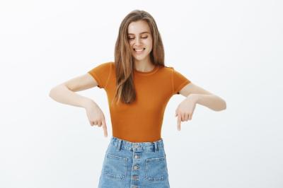 Attractive Woman Smiling and Pointing Down – Free Stock Photo, Download for Free
