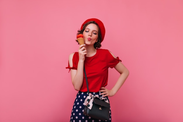 Blissful Girl with Black Handbag Enjoying Ice Cream – Free Stock Photo for Download