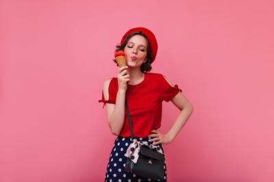 Blissful Girl with Black Handbag Enjoying Ice Cream – Free Stock Photo for Download