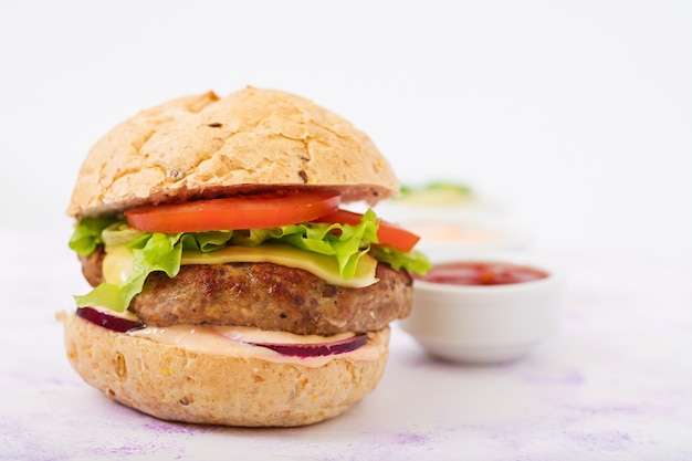 Big Sandwich: Juicy Beef Burger with Cheese, Tomato, and Red Onion alongside French Fries – Free Download