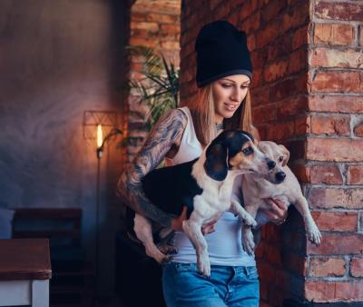 A Stylish Tattooed Blonde Holding Two Cute Dogs – Free Download