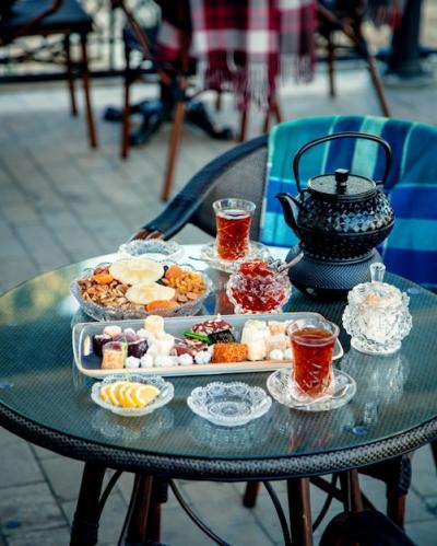 Tea Set Surrounded by Delicious Sweets and Black Tea – Free Download