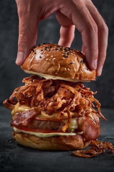 Male Hand Holding Burger Bun – Free Stock Photo for Download