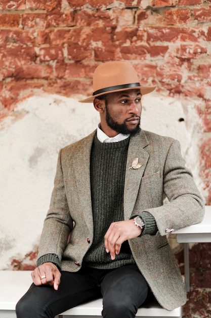 Handsome Man Posing with Brick Wall Background – Free Download
