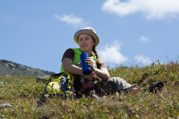 Stunning Mountain Landscape with Tourist Drinking from Bottle – Free Download
